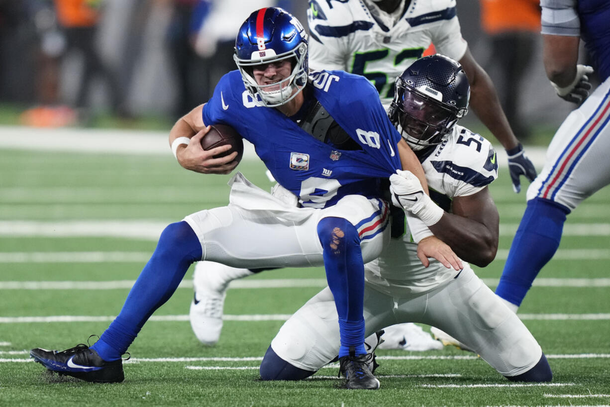 New York Giants quarterback Daniel Jones (8) is sacked by Seattle Seahawks linebacker Boye Mafe (53) during the fourth quarter of an NFL football game, Monday, Oct. 2, 2023, in East Rutherford, N.J.