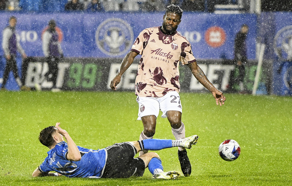 CF Montreal's Joel Waterman, left, challenges Portland Timbers' Dairon Asprilla, right, during second-half MLS soccer match action in the rain in Montreal, Saturday, Oct. 7, 2023.