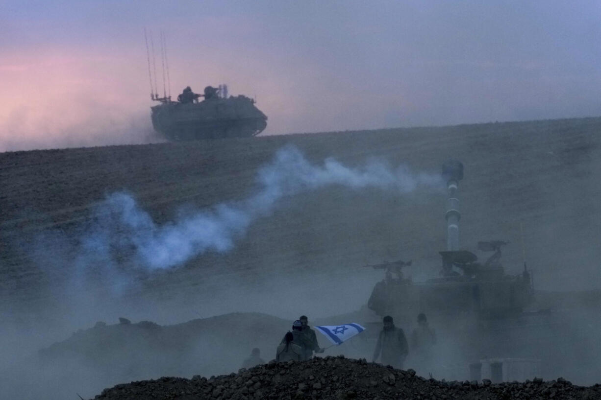 An Israeli mobile artillery unit fires a shell from southern Israel towards the Gaza Strip, in a position near the Israel-Gaza border, Israel, Saturday, Oct. 14, 2023.