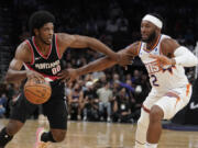 Phoenix Suns' Josh Okogie (2) guards against Portland Trail Blazers' Scoot Henderson (00) during the first half of a preseason NBA basketball game, Monday, Oct. 16, 2023, in Phoenix.