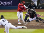 Philadelphia Phillies' Bryce Harper hits a home run off Arizona Diamondbacks starting pitcher Zac Gallen during the sixth inning in Game 5 of the baseball NL Championship Series in Phoenix, Saturday, Oct. 21, 2023.