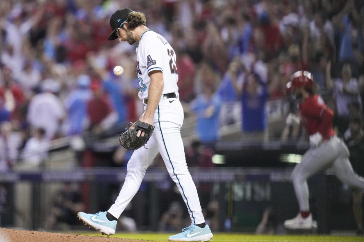 Philadelphia Phillies' Bryce Harper rounds the bases after a home run off Arizona Diamondbacks starting pitcher Zac Gallen during the sixth inning in Game 5 of the baseball NL Championship Series in Phoenix, Saturday, Oct. 21, 2023. (AP Photo/Ross D.