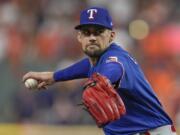 Texas Rangers starting pitcher Nathan Eovaldi thorws during the first inning of Game 6 of the baseball AL Championship Series against the Houston Astros Sunday, Oct. 22, 2023, in Houston. (AP Photo/Godofredo A.