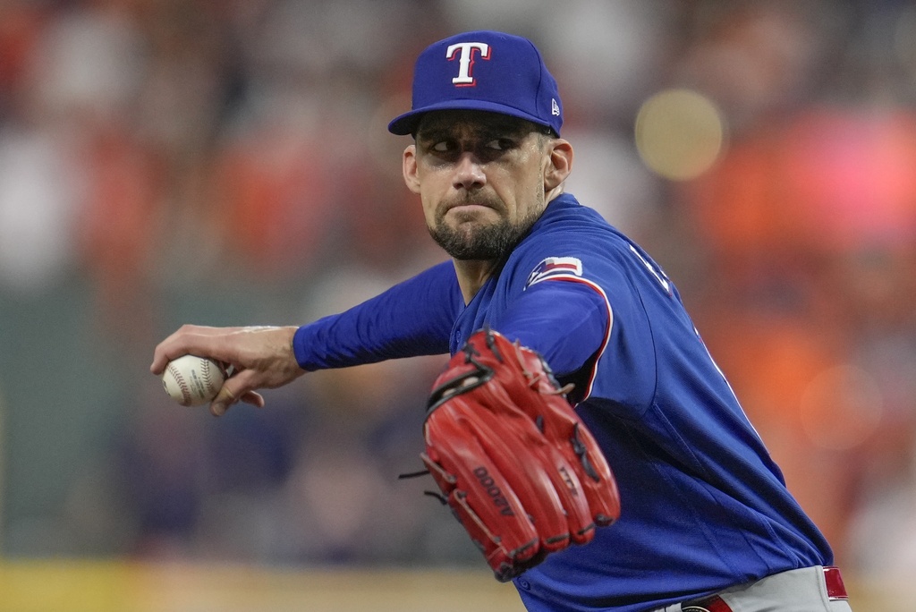 Texas Rangers starting pitcher Nathan Eovaldi thorws during the first inning of Game 6 of the baseball AL Championship Series against the Houston Astros Sunday, Oct. 22, 2023, in Houston. (AP Photo/Godofredo A.