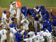 Texas Rangers' Adolis Garcia celebrates after hitting a game-winning home run against the Arizona Diamondbacks during the 11th inning in Game 1 of the baseball World Series Friday, Oct. 27, 2023, in Arlington, Texas. The Rangers won 6-5. (AP Photo/Godofredo A.