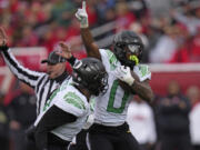 Oregon defensive back Tysheem Johnson (0) celebrates after making an interception against Utah during the first half of an NCAA college football game Saturday, Oct. 28, 2023, in Salt Lake City.