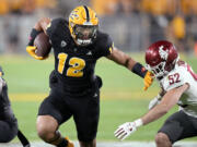 Arizona State tight end Jalin Conyers (12) runs with the ball as Washington State linebacker Kyle Thornton (52) tries to make a tackle during the first half of an NCAA college football game Saturday, Oct. 28, 2023, in Tempe, Ariz. (AP Photo/Ross D.