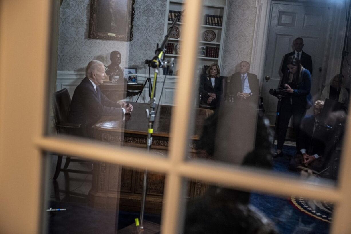 First lady Jill Biden, center, watches as President Joe Biden speaks from the Oval Office of the White House, Thursday, Oct. 19, 2023, in Washington, about the war in Israel and Ukraine.