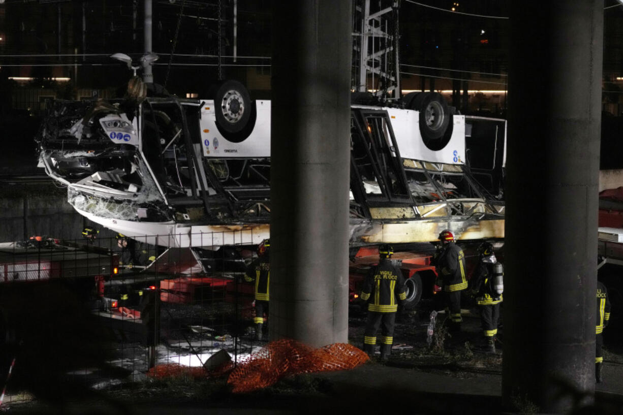 Italian firefighters work at the scene of a passenger bus accident in Mestre, near Venice, Italy, Wednesday, Oct. 4, 2023.