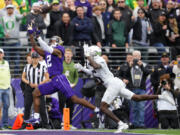 Washington wide receiver Ja'Lynn Polk (2) makes a touchdown catch against Oregon defensive back Khyree Jackson, right, during the first half of an NCAA college football game, Saturday, Oct. 14, 2023, in Seattle.