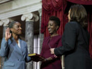 Vice President Kamala Harris, right, swears in Laphonza Butler, D-Calif., left, to the Senate to succeed the late Sen. Dianne Feinstein during a re-enactment of the swearing-in ceremony on Tuesday, Oct. 3, 2023, on Capitol Hill in Washington. Butler's wife, Neneki Lee, center, holds the Bible.