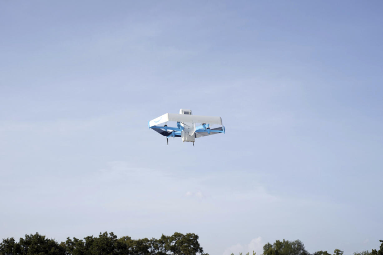 This photo provided by Amazon shows a drone delivering prescription drugs in College Station, Texas.(Amazon via AP)