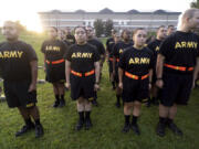 FILE - Students in the new Army prep course stand at attention after physical training exercises at Fort Jackson in Columbia, S.C., Aug. 27, 2022. The Army is launching a sweeping overhaul of its recruiting to focus more on young people who have spent time in college or are job hunting early in their careers. The aim is to reverse years of enlistment shortfalls.