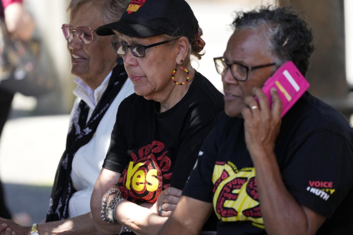 Indigenous women sit on a bench at a polling place in Redfern as Australians cast their final votes in Sydney, Saturday, Oct. 14, 2023, in their first referendum in a generation that aims to tackle Indigenous disadvantage by enshrining in the constitution a new advocacy committee. The prospect of an Indigenous Voice to Parliament has bitterly divided Australia's Indigenous minority as well as the wider community.