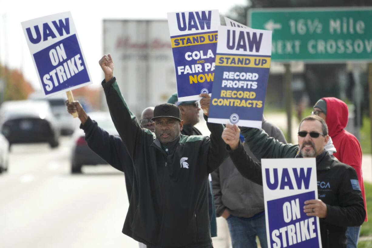 FILE - United Auto Workers members walk the picket line during a strike at the Stellantis Sterling Heights Assembly Plant, in Sterling Heights, Mich., Monday, Oct. 23, 2023. Jeep maker Stellantis has reached a tentative contract agreement with the United Auto Workers union that follows a template set earlier this week by Ford, two people with knowledge of the negotiations said Saturday, Oct. 28, 2023.