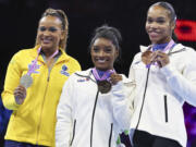 United States' Simone Biles, center and gold medal, Brazil's Rebeca Andrade, left and silver medal and United States' Shilese Jones, right and bronze medal, pose on the podium after the women's all-round final at the Artistic Gymnastics World Championships in Antwerp, Belgium, Friday, Oct. 6, 2023.