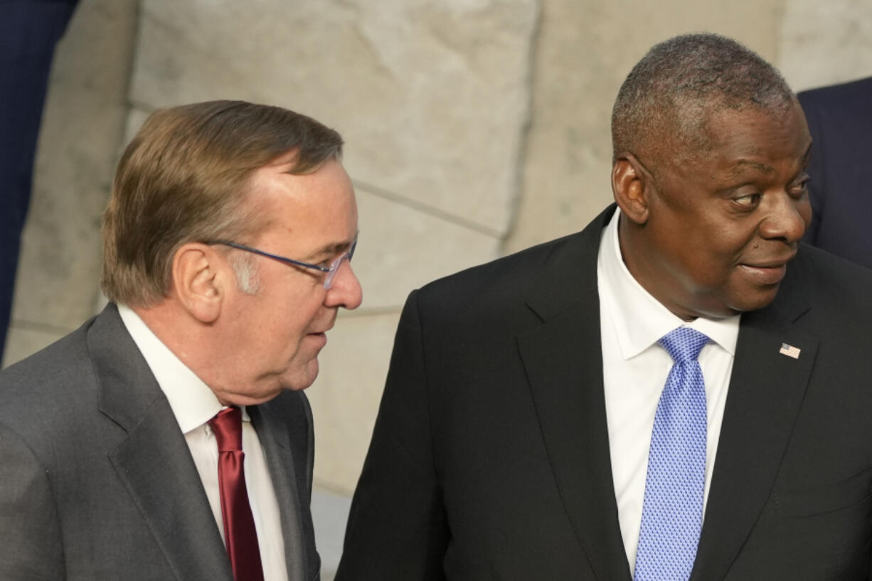 United States Secretary of Defense Lloyd Austin, right, speaks with Germany's Defense Minister Boris Pistorius during a group photo during a meeting of the North Atlantic Council in defense ministers format at NATO headquarters in Brussels, Thursday, Oct. 12, 2023.