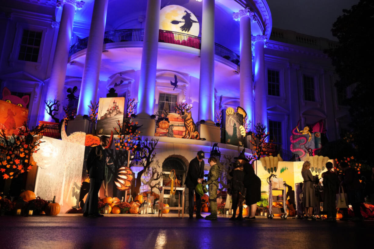 President Joe Biden and first lady Jill Biden give treats to trick-or-treaters on the South Lawn of the White House, on Halloween, Monday, Oct. 30, 2023.