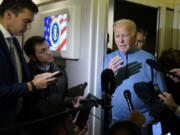 President Joe Biden talks to reporters aboard Air Force One during a refueling stop in at Ramstein Air Base in Germany, Wednesday, Oct. 18, 2023, as he travels back from Israel to Washington.