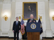 Secretary of State Antony Blinken, left, listens as President Joe Biden speaks in the State Dining Room of the White House, Saturday, Oct. 7, 2023, in Washington. The militant Hamas rulers of the Gaza Strip have carried out an unprecedented, multifront attack on Israel, firing thousands of rockets as dozens of Hamas fighters infiltrated the heavily fortified border in several locations and catching the country off-guard on a major holiday.