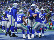 Seattle Seahawks wide receiver Jaxon Smith-Njigba, center, celebrates with teammates after scoring a touchdown late in the second half of an NFL football game against the Cleveland Browns, Sunday, Oct. 29, 2023, in Seattle.