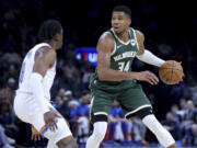 Milwaukee Bucks forward Giannis Antetokounmpo (34) looks to get by Oklahoma City Thunder forward Jalen Williams (8) in the second half of a preseason NBA basketball game, Tuesday, Oct. 17, 2023, in Oklahoma City.