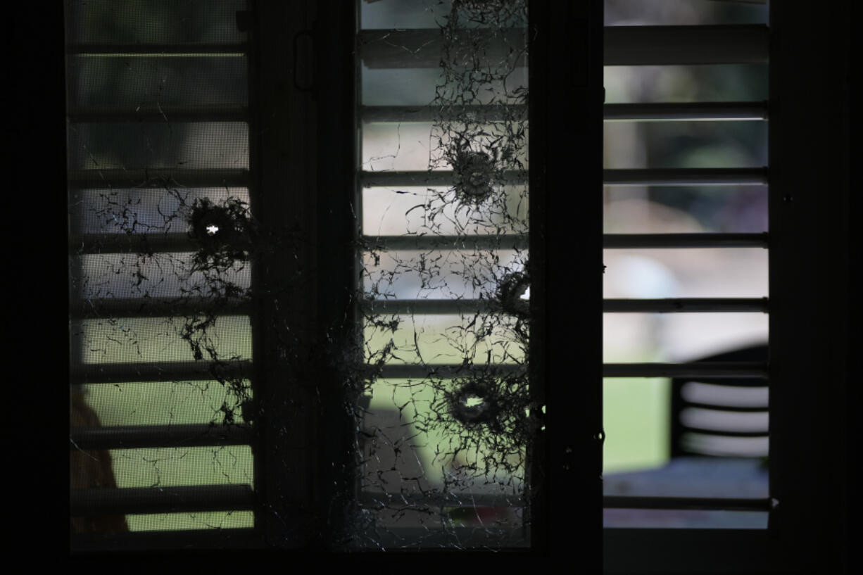 CORRECTS DAY TO SATURDAY - Bullet shaterred window of a house is seen in kibbutz Kfar Azza on Tuesday, Oct. 10, 2023. Hamas militants overran Kfar Azza on Saturday, where many Israelis were killed and taken captive.