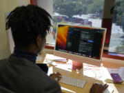 Post-doctoral researcher Tofunmi Omiye looks over chatbots in his office at the Stanford School of Medicine in Stanford, Calif., Tuesday, Oct. 17, 2023. A new study, co-led by Omiye, cautions that popular chatbots are perpetuating racist, debunked medical ideas, prompting concerns that the tools could worsen health disparities for Black patients.