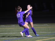 Columbia River’s Paige Johnson (12) celebrates with Avah Eslinger after Eslinger scored a goal in a 1-0 win over Ridgefield in a girls soccer match at Columbia River High School on Tuesday, Oct. 3, 2023.