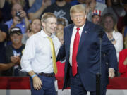 FILE - Then-President Donald Trump, right, encourages Rep. Jim Jordan, R-Ohio, left, to speak during a rally, Saturday, Aug. 4, 2018, in Lewis Center, Ohio.