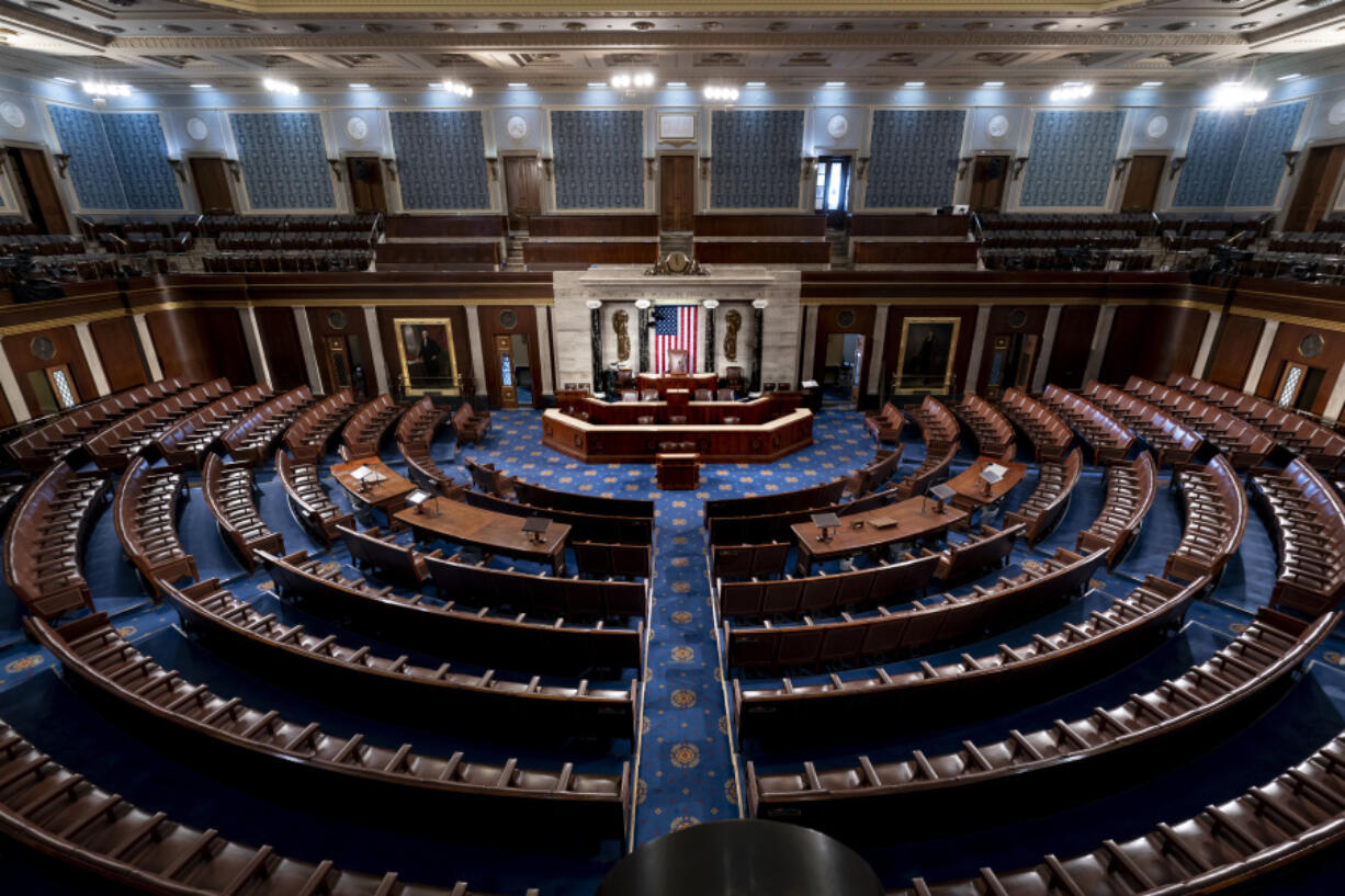 FILE - The empty chamber of the House of Representatives is seen at the Capitol in Washington, Feb. 28, 2022. Republicans have chosen congressman Mike Johnson of Louisiana as their latest nominee for House speaker. Johnson will face a floor vote Wednesday, Oct. 25, 2023, trying to unify the divided GOP majority. Johnson is the fourth candidate Republicans have nominated to replace Kevin McCarthy on Oct. 3, 2023. (AP Photo/J.