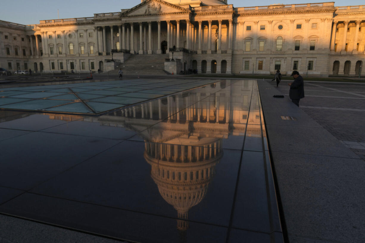 The U.S. Capitol is seen on a sunrise as people pass by on Tuesday, Oct. 24, 2023, in Washington. House Republicans will meet privately to try nominating a new House speaker. It's three weeks since Republicans ousted Kevin McCarthy. The House speaker will need to accomplish the seemingly impossible job of uniting a broken, bitter GOP majority and returning to the work of Congress.