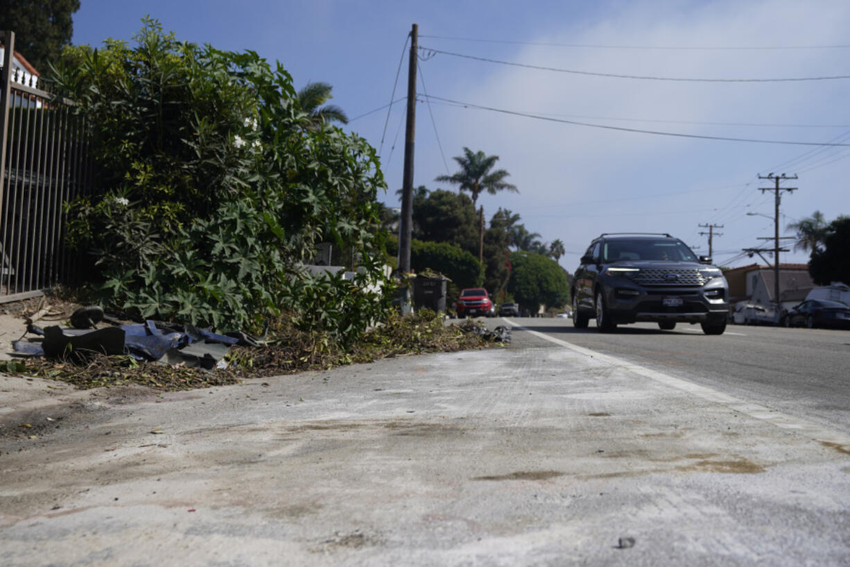 Debris is seen along the Pacific Coast Highway, Wednesday, Oct. 18, 2023, in Malibu, Calif. Tuesday. A 22-year-old driver was arrested on suspicion of manslaughter after a crash in Malibu killed four women, who are believed to be college students, and injured two others, officials said Wednesday. The six pedestrians were struck at about 8:30 p.m. Tuesday along Pacific Coast Highway about 4 miles (6.4 km) east of Pepperdine University, according to the Los Angeles County Sheriff's Department.