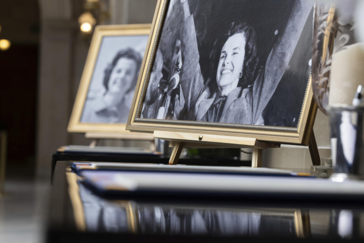 FILE - Pictures of U.S. Sen. Dianne Feinstein sit beside a condolence book for the senator at City Hall in San Francisco on Friday, Sept. 29, 2023. The body of the late senator will lie in state Wednesday, Oct. 4, at San Francisco's City Hall for mourners wishing to say goodbye to their 'forever mayor.' It is the building where Feinstein served as supervisor and the city's first female mayor before departing for a groundbreaking career in Congress three decades ago.