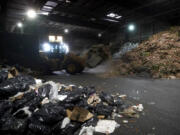 Organic material is picked up to be loaded onto a truck at a GreenWaste Zanker Resource Recovery Facility in San Jose, Calif., Friday, Oct. 27, 2023. A pair of recent reports from the EPA put striking numbers to the problem of food waste: one-third of the food produced in the U.S. is never eaten. California began requiring every jurisdiction to provide organic waste collection services starting in 2022.