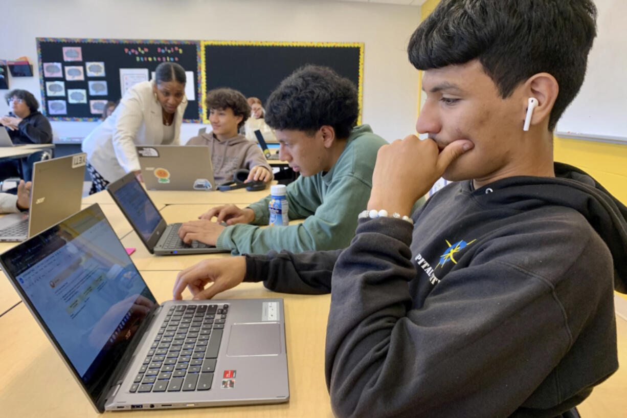 Bryan Martinez, a senior at Capital City Public Charter School in Washington, works on a computer Sept. 12 during his Advanced Algebra with Financial Applications class. For his medium-term financial goals, he settles on a car -- he doesn't have one yet -- and vacations.