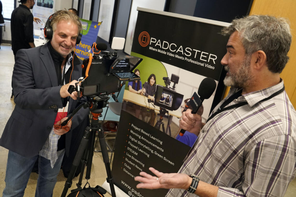 PADCASTER President Jon Goldberg, left, and CEO Josh Apter, demonstrate their Padcaster Studio for remote and virtual learning, at EDTECHWEEK 2023, in New York, Tuesday, Oct. 3, 2023. As soon as the federal pandemic relief started arriving at America's schools, tech companies by the dozens wanted a chance to prove that their software or equipment was exactly what schools needed.