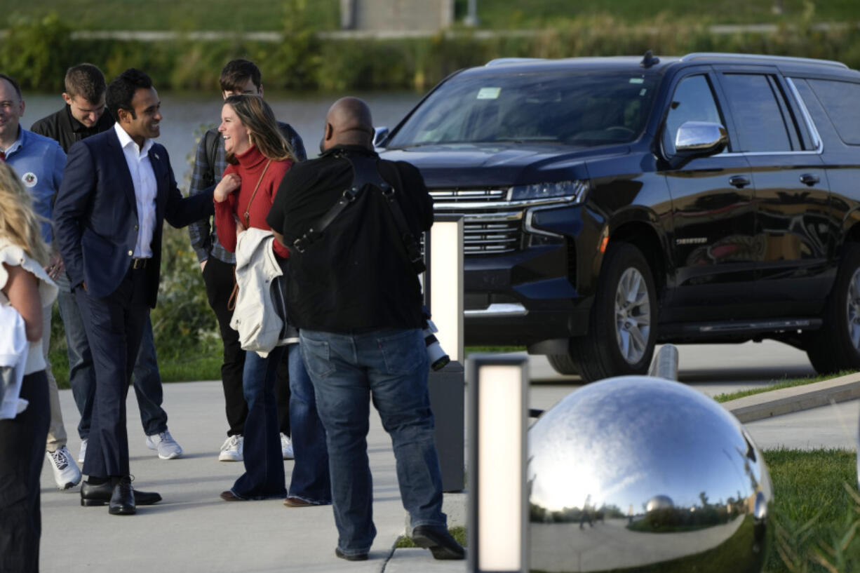 Republican presidential candidate Vivek Ramaswamy, left, talks with supporters during a campaign event, Thursday, Oct. 5, 2023, in West Des Moines, Iowa.