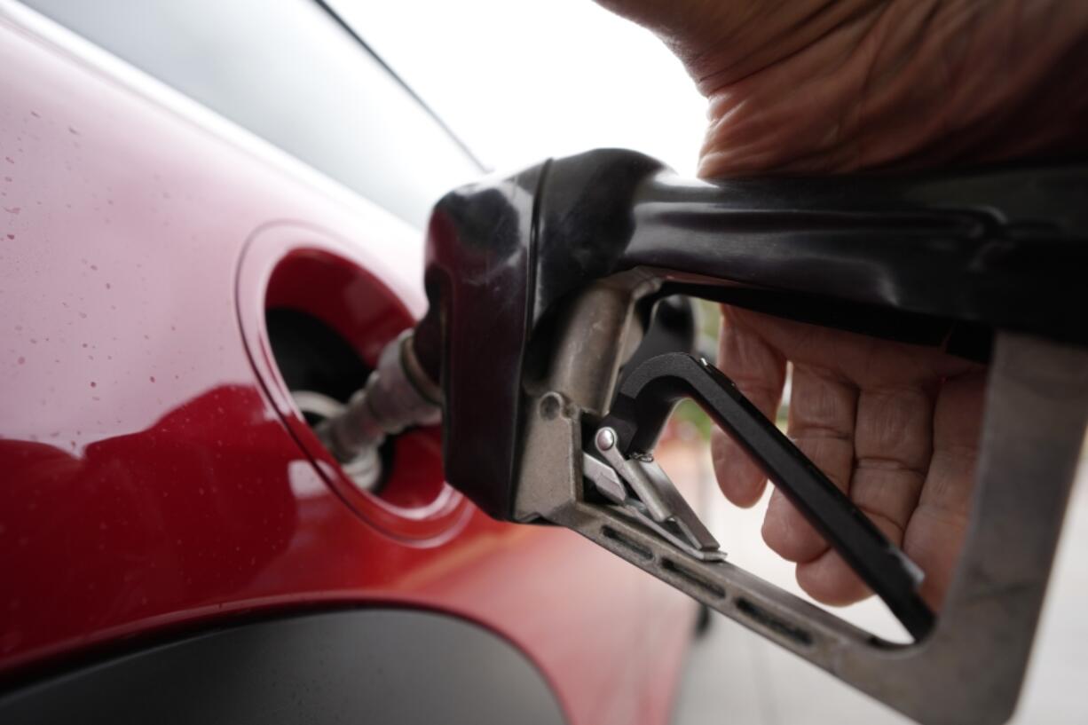 FILE A motorist finishes filling up the tank of a vehicle at a Shell station, July 5, 2023, in Englewood, Colo. The IEA's annual world energy outlook, which analyzes the global picture of energy supply and demand, was released Tuesday, Oct. 24.