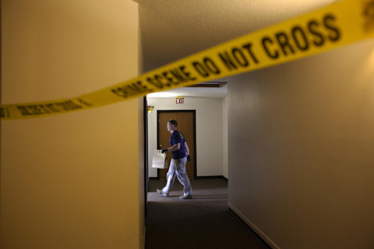 FILE - An FBI Evidence Response Team investigator walks behind crime scene, July 15, 2023, in Fargo, N.D. Data in the FBI's annual crime report released Monday, Oct. 16, 2023 shows that violent crime across the U.S. decreased last year, dropping to about the same level as before the onset of the COVID-19 pandemic.