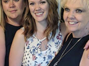 Brianna Hayes, center, poses with her older sister Darci Hayes, left, and mother Sharon Hayes, right, in June 2019 after graduating from her graduate school program at Eastern Washington University in Cheney, Wash. Sharon Hayes, of Hauser, Idaho, sued her former fertility doctor in Spokane on Wednesday, Oct. 25, 2023, saying that he secretly used his own sperm to inseminate her when she became pregnant with her second daughter 34 years ago - information Brianna Hayes said she discovered after taking an at-home DNA test.