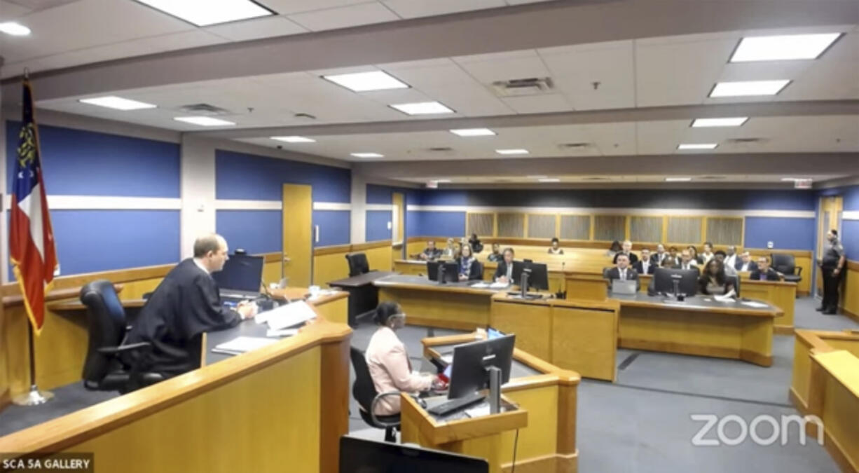 In this frame grab from video, Sidney Powell, former attorney for former President Donald Trump, attends a hearing with her attorney Brian Rafferty before Judge Scott McAfee on Thursday, Oct. 19, 2023 at the Fulton County Courthouse in Atlanta.  Powell pleaded guilty in the Georgia election interference case and was sentenced to six years probation, a fine, and she will be required to testify in future trials.