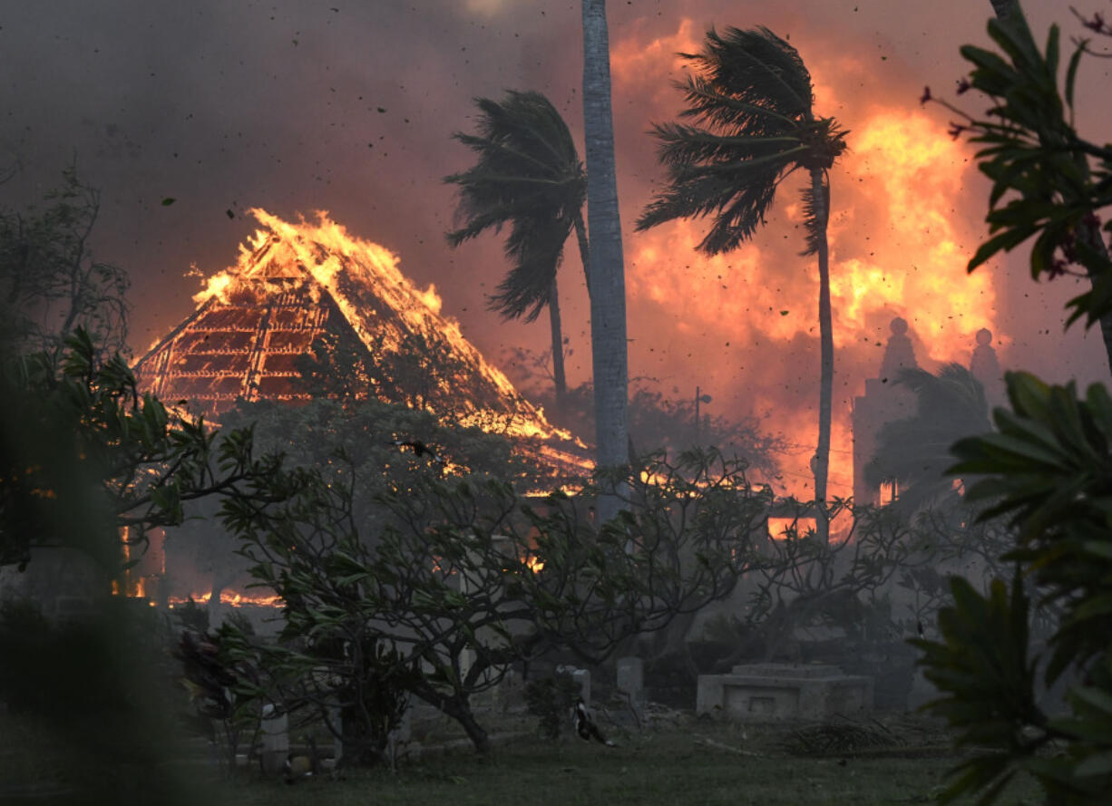 FILE - The hall of historic Waiola Church in Lahaina and nearby Lahaina Hongwanji Mission are engulfed in flames along Wainee Street on Aug. 8, 2023, in Lahaina, Hawaii.