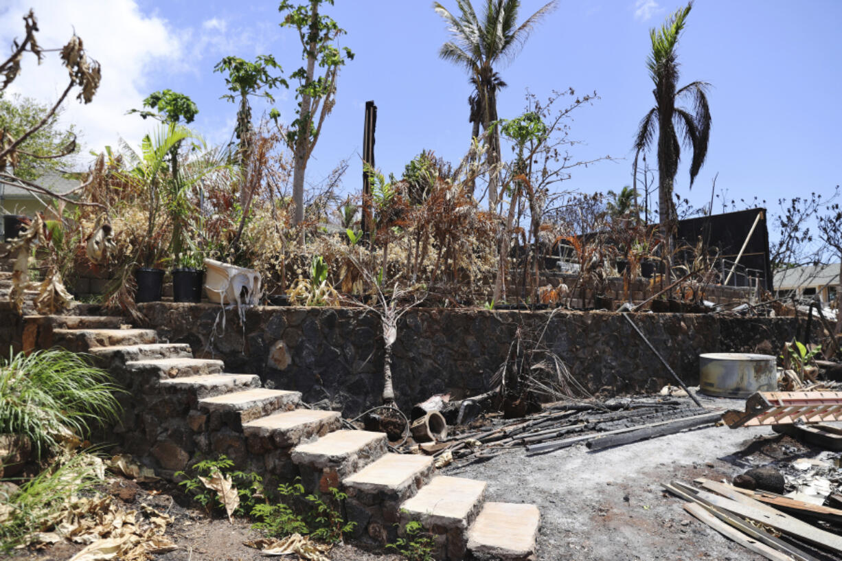 The ruins of a home destroyed by a deadly August wildfire lay outside the boundary of a Hawaiian homestead community in Lahaina, Hawaii, on Friday, Sept. 1, 2023. The Villages of Leiali'I, a Native Hawaiian neighborhood, lost only two out of 104 houses, even though many homes were destroyed in other parts of Lahaina.
