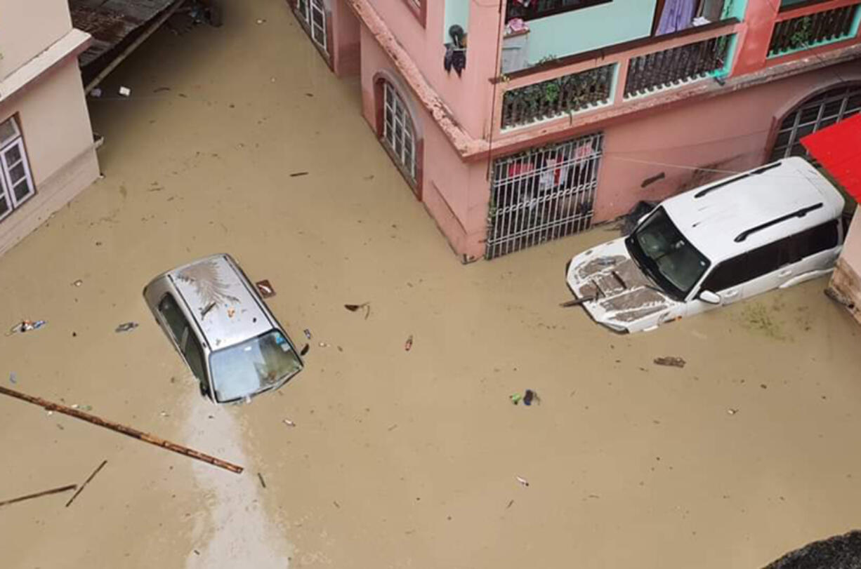 Cars lie submerged in water after flash floods triggered by a sudden heavy rainfall swamped the Rangpo town in Sikkim, India, Thursday, Oct.5. 2023. The flooding took place along the Teesta River in the Lachen Valley of the north-eastern state, and was worsened when parts of a dam were washed away.