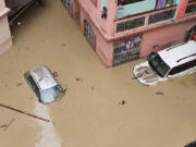 Cars lie submerged in water after flash floods triggered by a sudden heavy rainfall swamped the Rangpo town in Sikkim, India, Thursday, Oct.5. 2023. The flooding took place along the Teesta River in the Lachen Valley of the north-eastern state, and was worsened when parts of a dam were washed away.