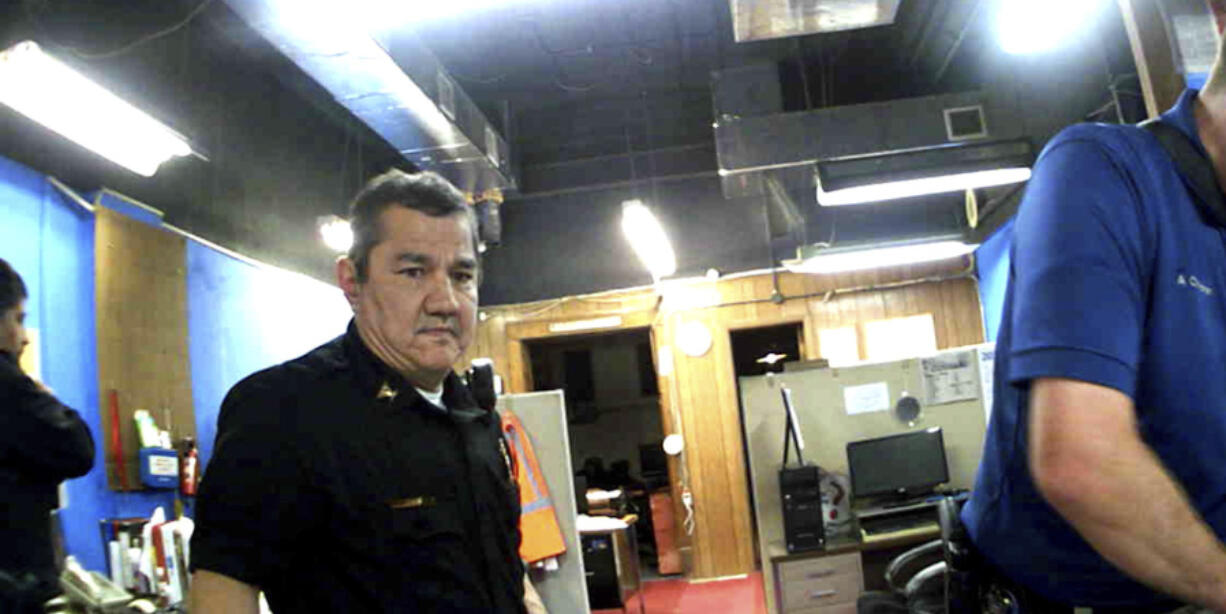 This image from Marion, Kan., Police Department body camera video provided by the McDonald Tinker law firm shows former Marion Police Chief Gideon Cody during his department's raid of the Marion County Record newspaper, Aug. 11, 2023, in Marion.