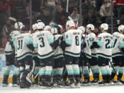 Seattle Kraken players celebrate after Jordan Eberle scored against the Detroit Red Wings during overtime of an NHL hockey game Tuesday, Oct. 24, 2023, in Detroit.