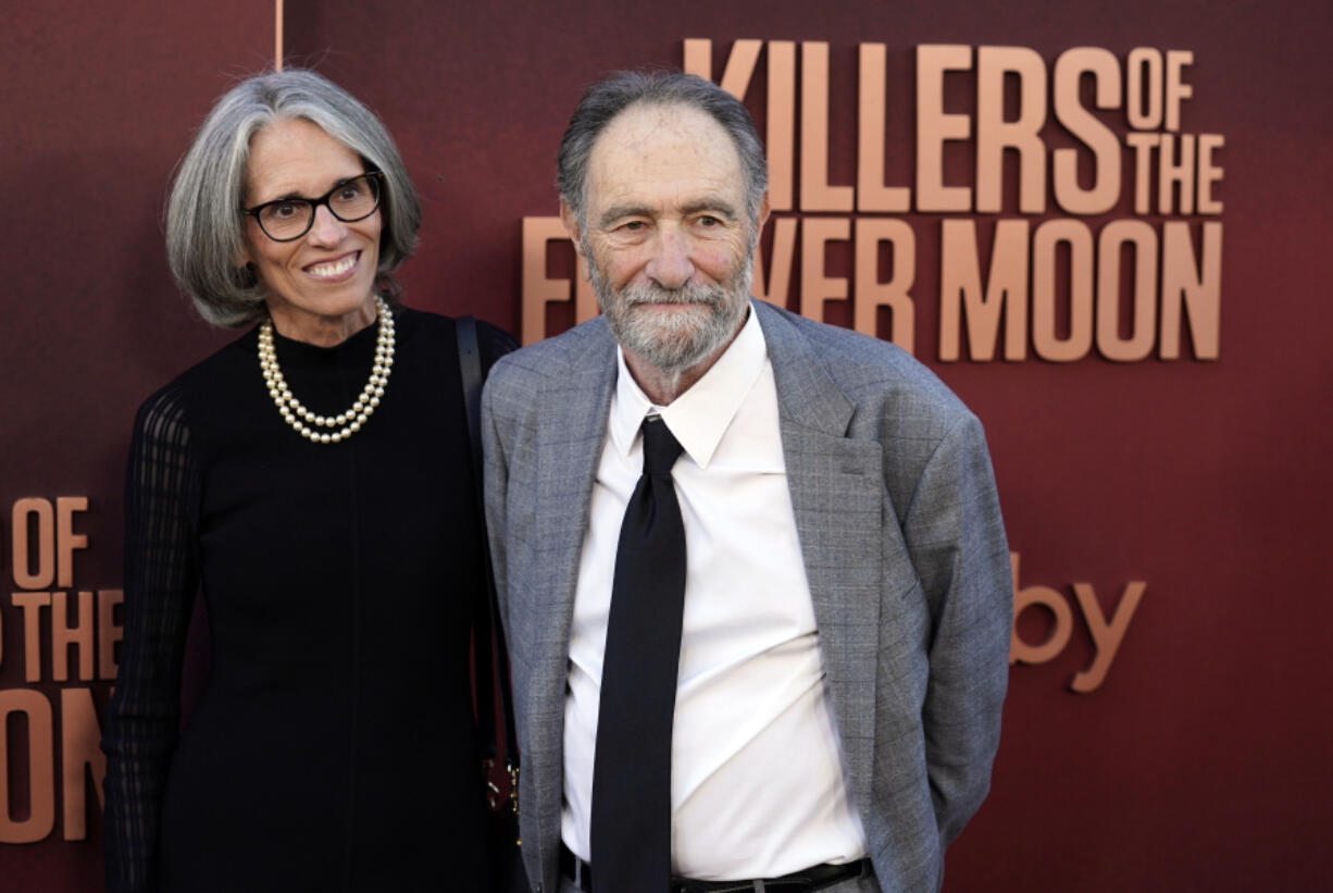 Eric Roth, right, co-writer of "Killers of the Flower Moon," arrives with Dr. Anne Peters at the Los Angeles premiere of the film, Monday, Oct. 16, 2023, at the Dolby Theater.