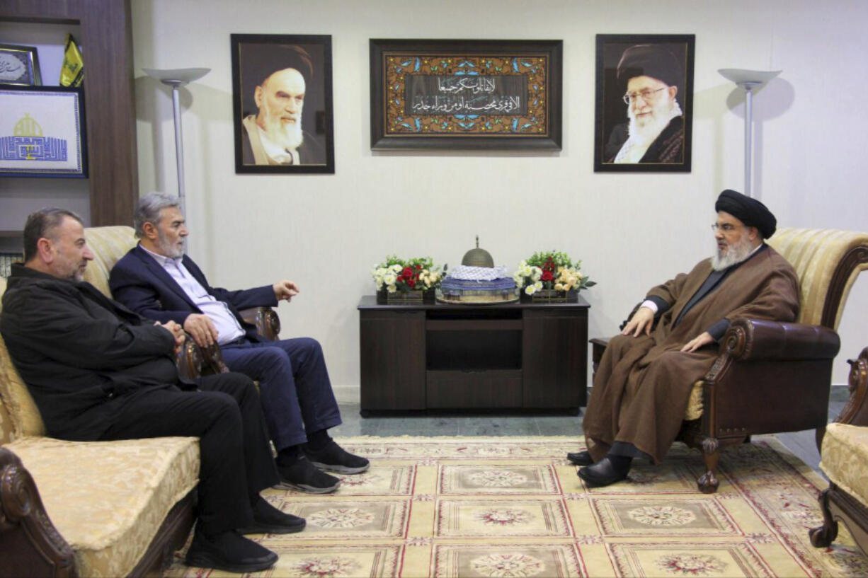 In this photo released on Wednesday, Oct. 25, 2023, by the Hezbollah Media Relations Office, Hezbollah leader Sayyed Hassan Nasrallah, right, meets with Ziad al-Nakhleh, the head of Palestinian Islamic Jihad, center, and Hamas deputy chief, Saleh al-Arouri, in Beirut, Lebanon. Nasrallah met with top Hamas and Palestinian Islamic Jihad officials, their first reported meeting since the Hamas-Israel war erupted earlier this month and clashes began along the Lebanon-Israel border.